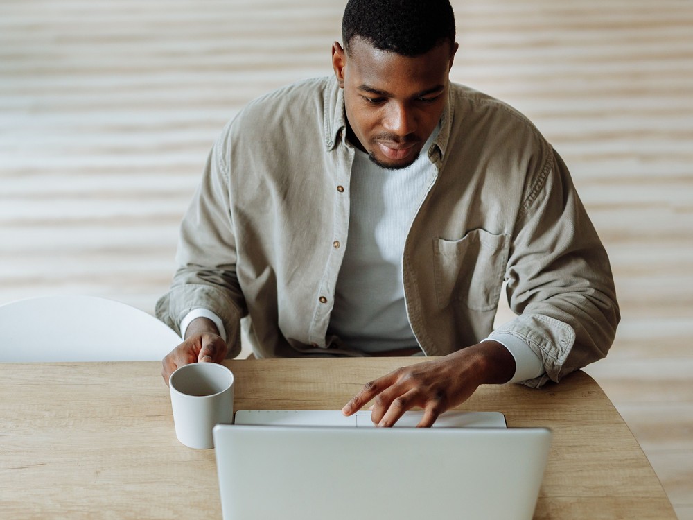 A man at a laptop at home, in an online one-to-one session